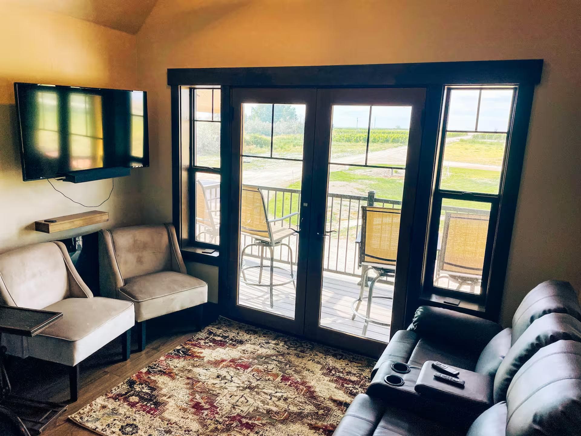 Main living area showing seating and access to outdoor balcony